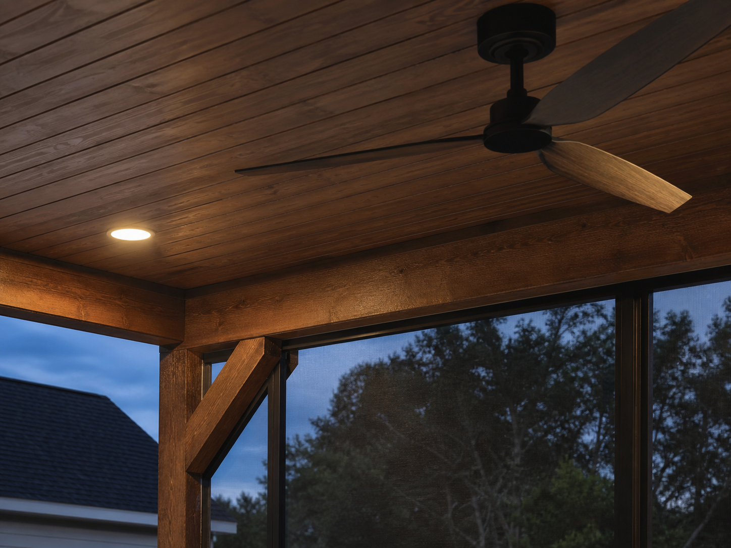 Covered porch wood ceiling detail with fan, recessed light, beams, and screened framing